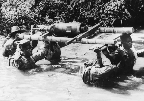 Men of a West African light battery fording a stream